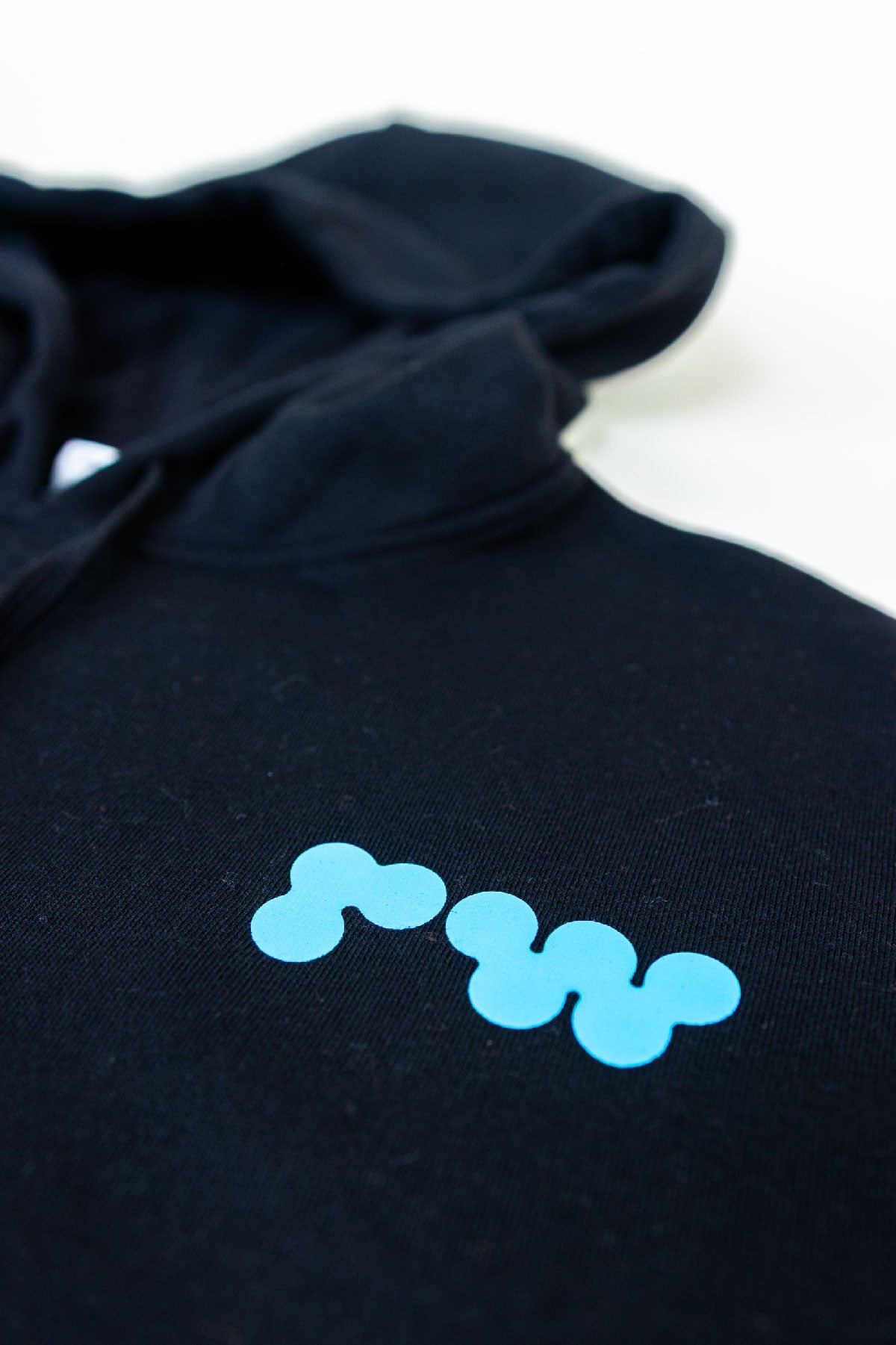 Black hoodie with blue abstract design on a white background