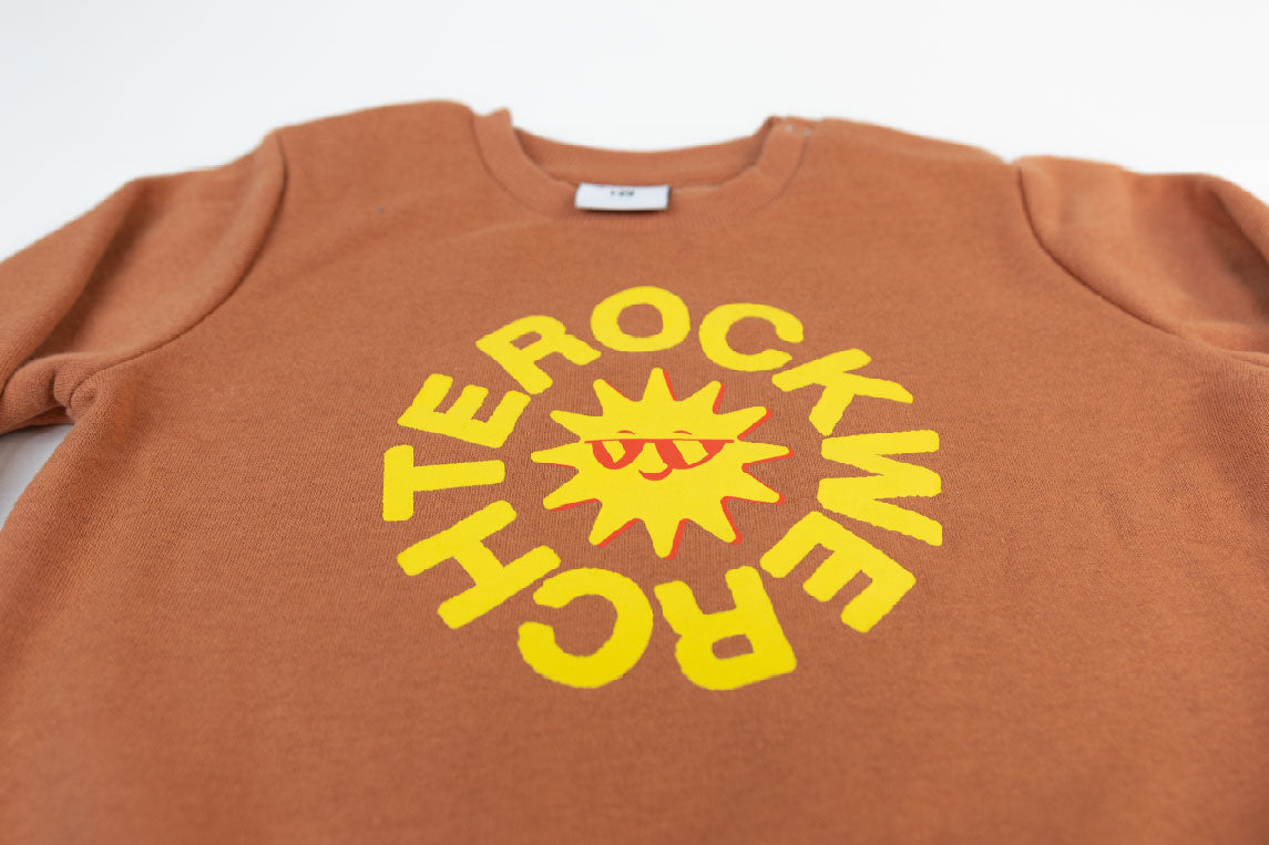 Brown sweatshirt with yellow graphic design on a white background