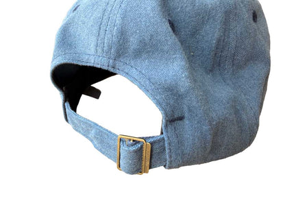 Blue denim cap with a gold buckle on a white background