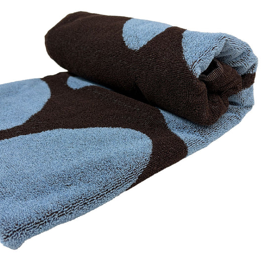 Folded towel with blue and brown pattern on a white background