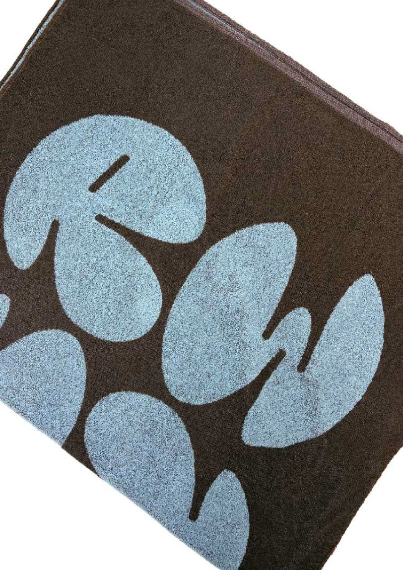 Close-up of a brown wallet with blue leaf pattern