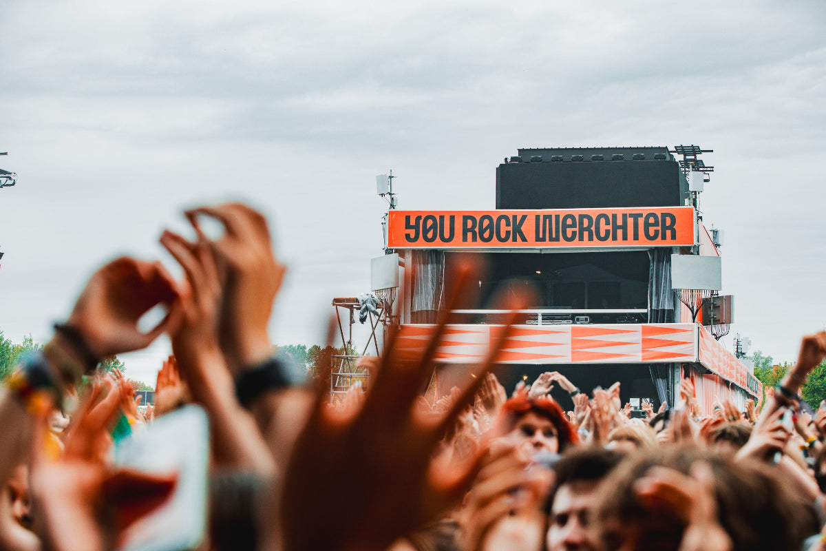 Crowd at a music festival with 'YOU ROCK Utrecht' sign in the background